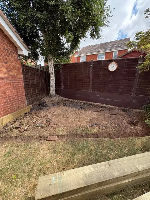 A garden corner excavated and squared up ready for a patio