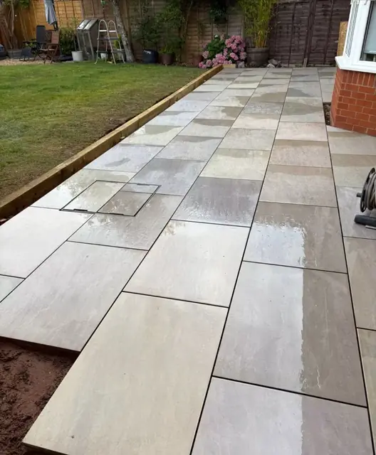 A grey slab garden path with lawn either side