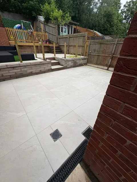 A white porcelain patio with a channel drain set into the edge