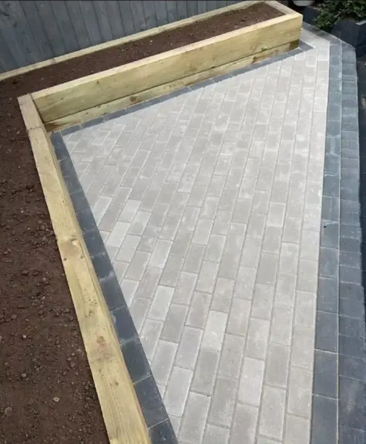 Porcelain paving finished against a new timber edge