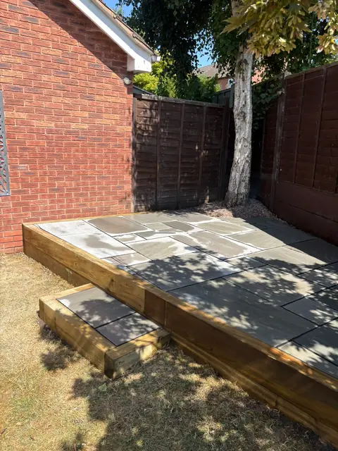 A raised patio built up and edged in new timber